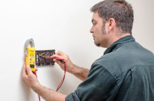Technician repairing thermostat.