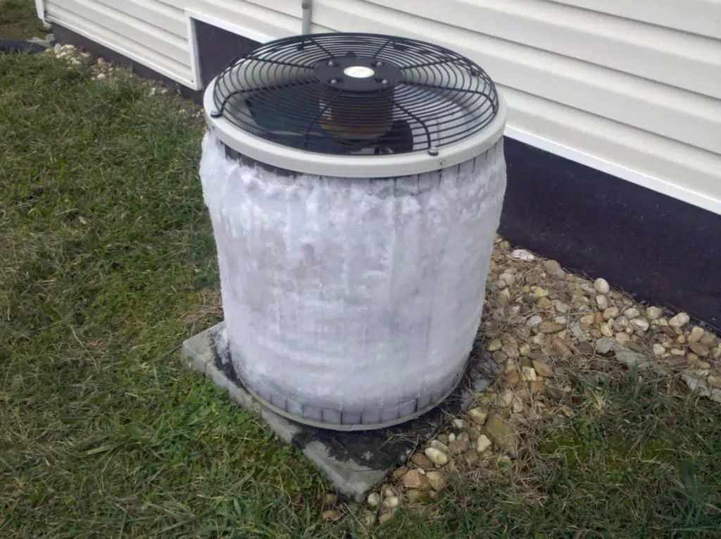 Frozen air conditioning unit outside of home.