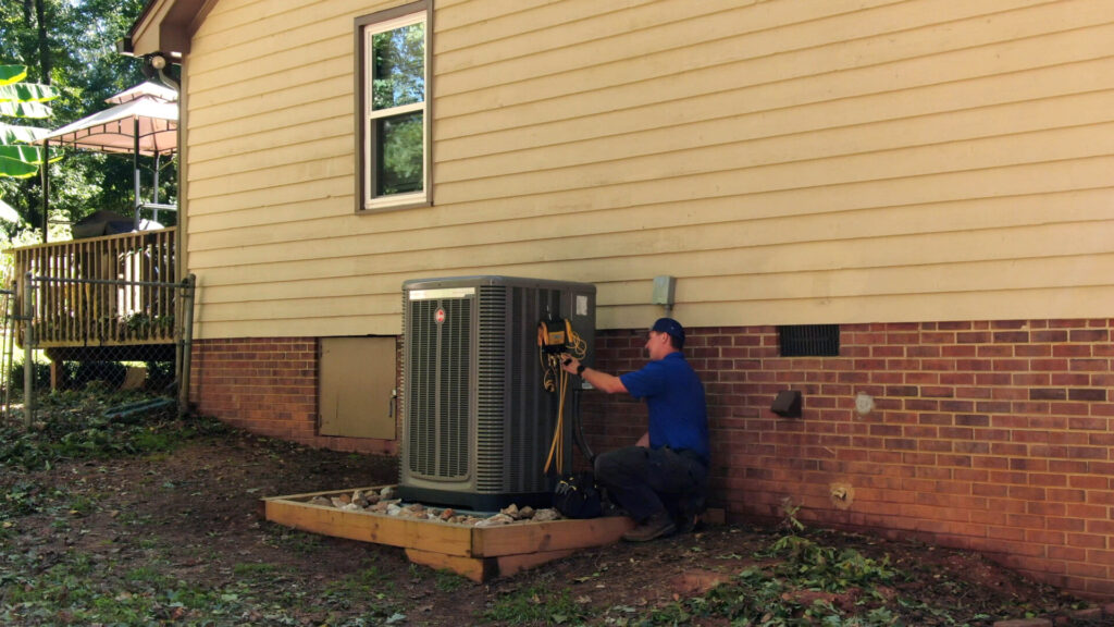 One of our HVAC technicians from Air Experts working on an outside unit 